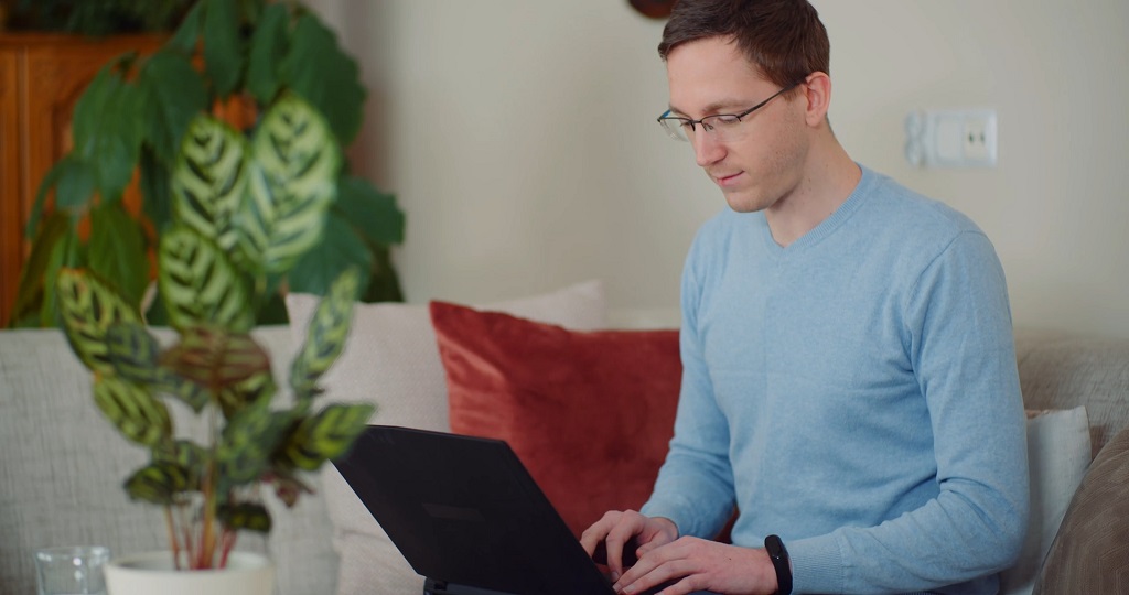 A Man Typing an Email on a Laptop